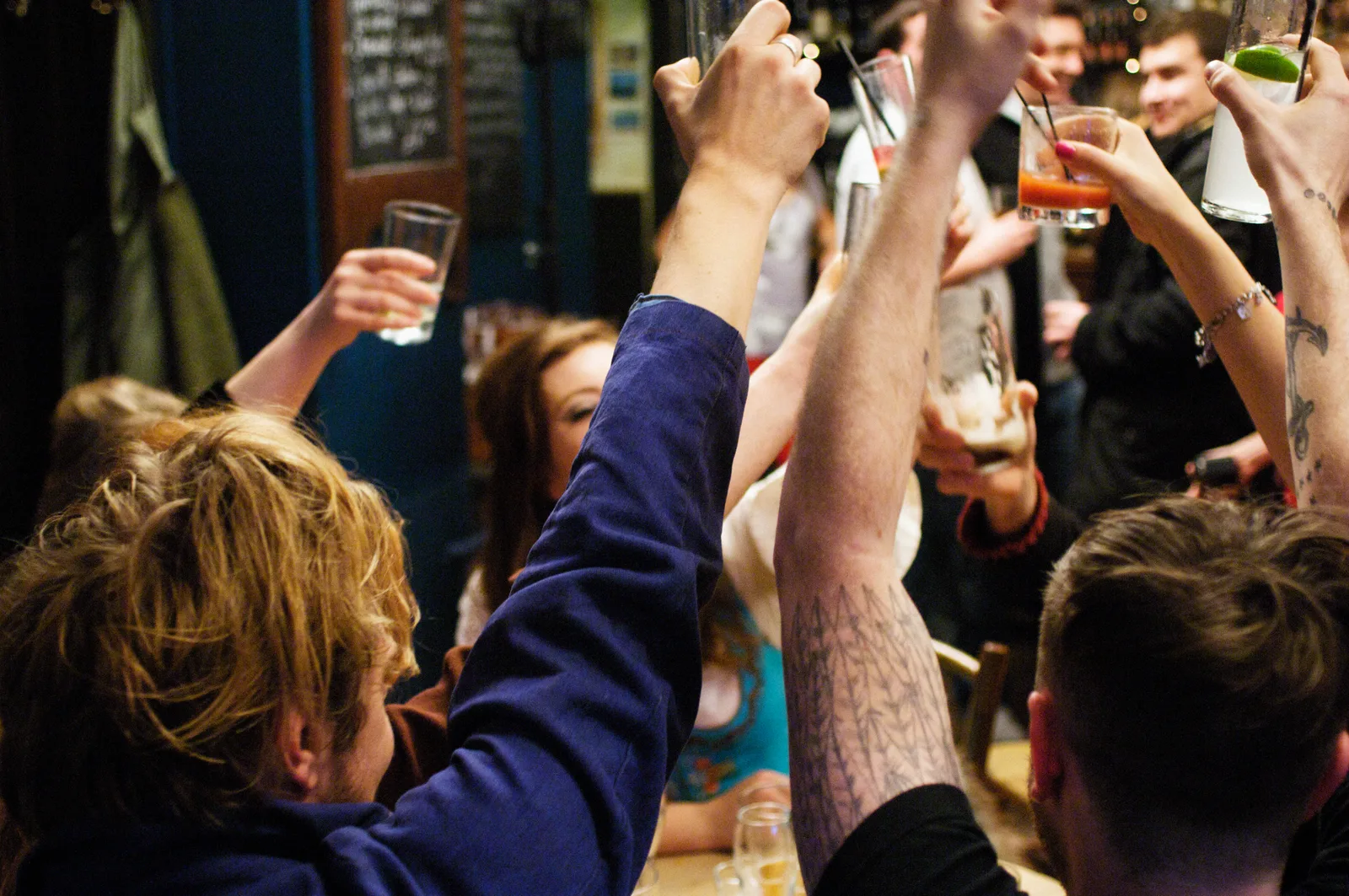 Guests raising drinks together at Tenoch Grill & Bar