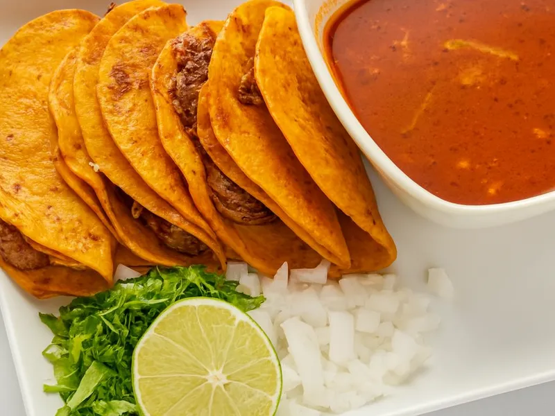 Tacos Quesabirria with birria consomé at Tenoch